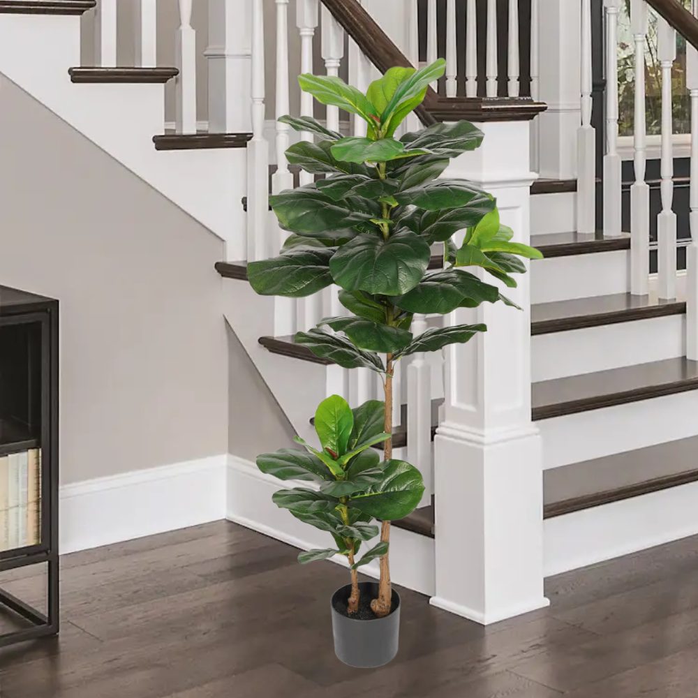An artificial fiddle leaf fig standing in a pot